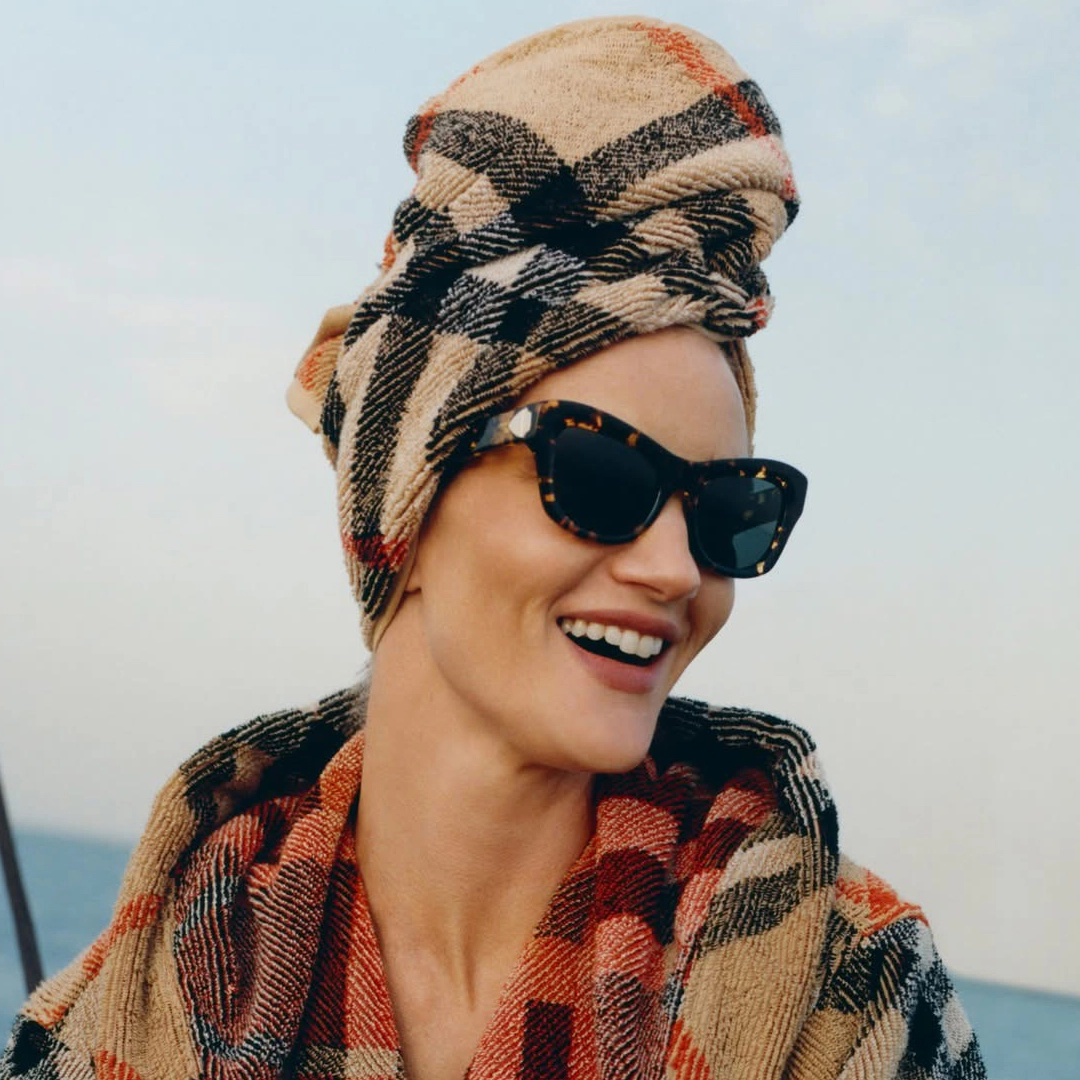 A woman wearing timeless Burberry eyewear with a modern British edge.