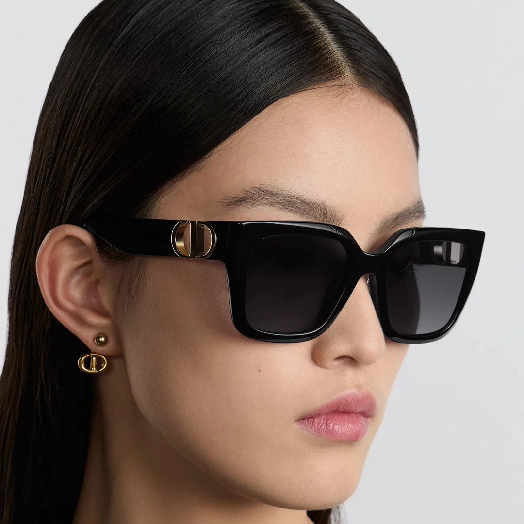 A woman wearing elegant and sophisticated DIOR sunglasses.