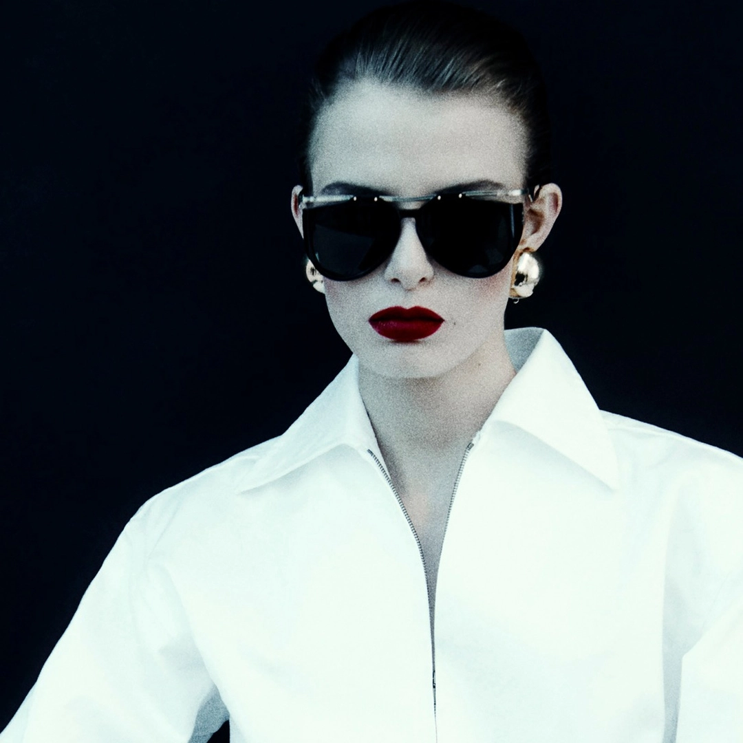 A model wearing sleek and rebellious Saint Laurent sunglasses.